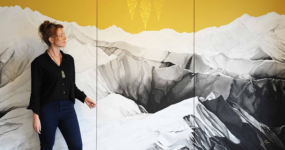 Artist Sofia Minson with her 3 metre wide painting "Te Waka a Māui" looking out over the Southern Alps