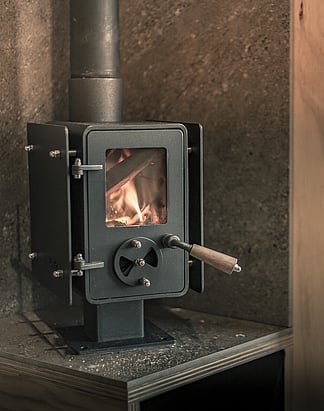 Wood burner fire | Boutique accommodation |  Northland accommodation | Tucked in an olive grove, relax in a hammock outdoors