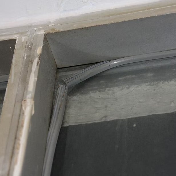 Rubber wedge seal that has come loose away from the corner