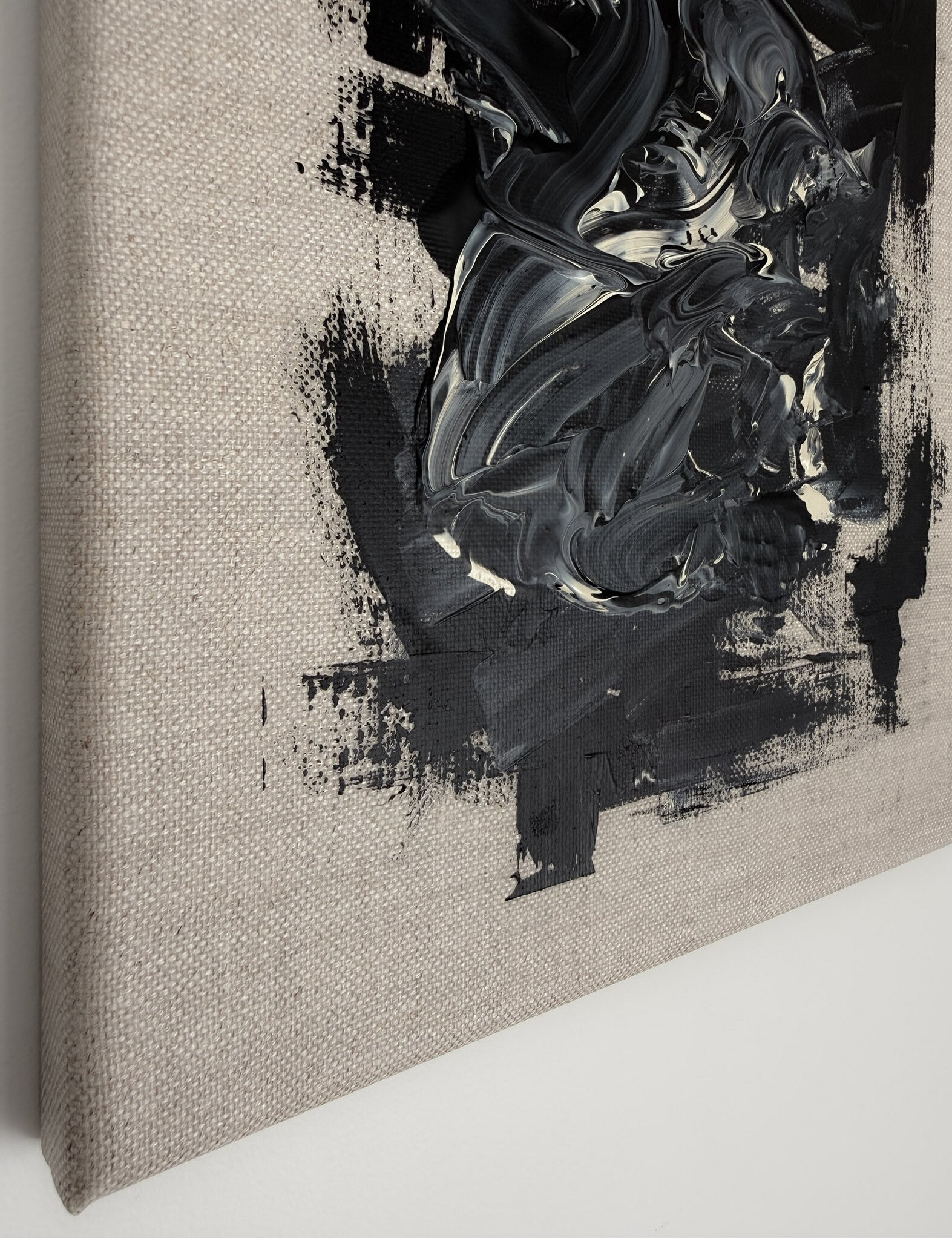side view showing black and pale cream textural impasto buildup of acrylic toward the linen edge, dragged paint marks, exposed linen weave and canvas depth