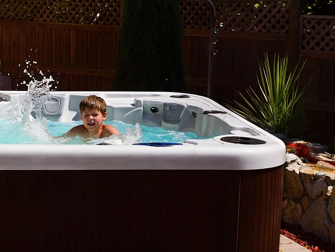boy swimming in swim spa