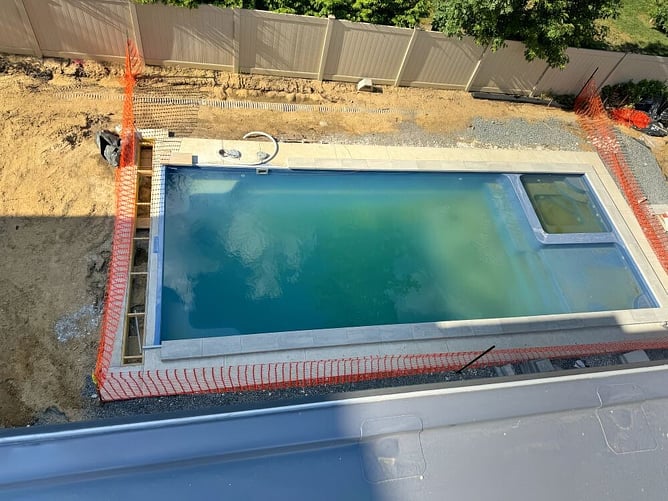concrete pool and drainage being installed