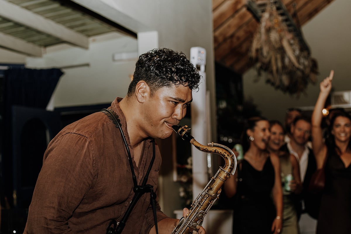Mahlon Saumalu playing saxophone with Motiv Entertainment
