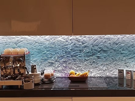 Water pattern on clear glass with coloured LED changing light splashback