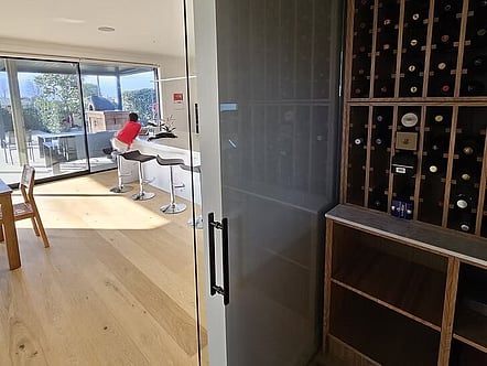 Sliding glass door with black hardware for wine cellar