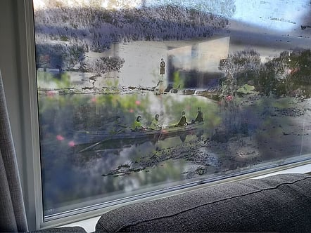Transparent printed layer of double glazed unit to create a unique art piece and privacy at this Lake home