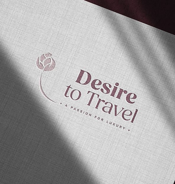 Desire to travel logo on testured paper showing a rebrand by Poppyseed Design