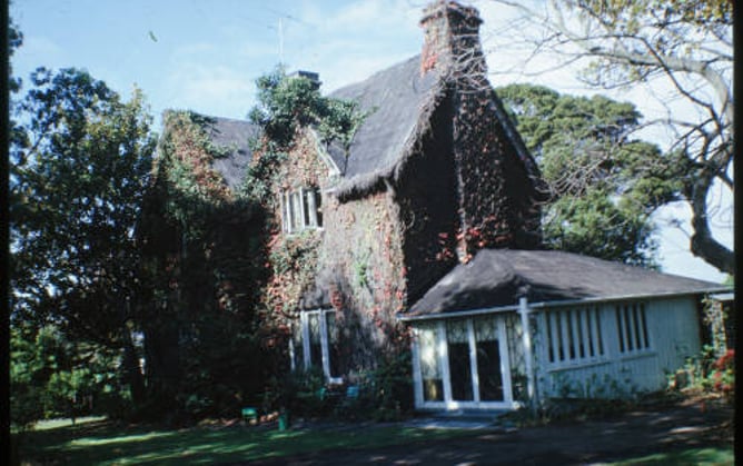 Nineteenth-century two storey building in an established garden.