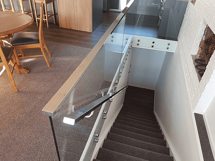 50mm stainless double disc standoffs, 12mm toughened glass and polished top cap handrail