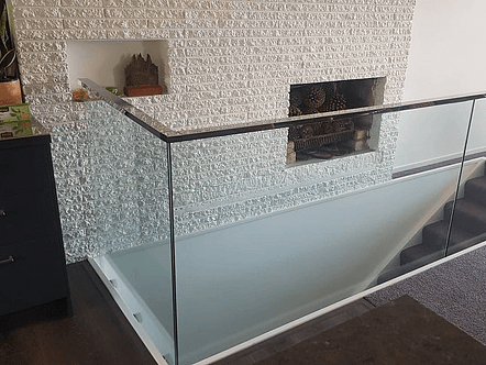 50mm stainless double disc standoffs, 12mm toughened glass and polished top cap handrail