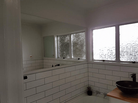 Large flush mount mirror custom built for surrounding cabinetry