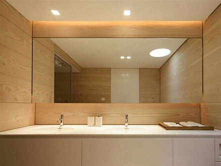 Large flush mount mirror custom built for surrounding cabinetry