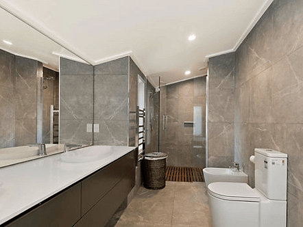 Large flush mount mirror custom built for surrounding cabinetry