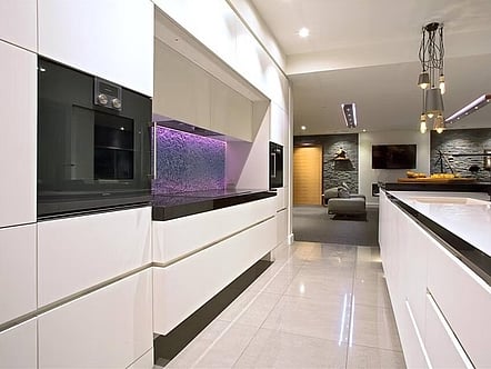 Water pattern on clear glass with coloured LED changing light splashback