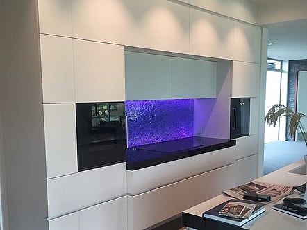 Water pattern on clear glass with coloured LED changing light splashback