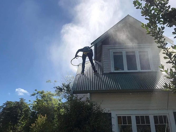 Dry gutts working on a two level home roof