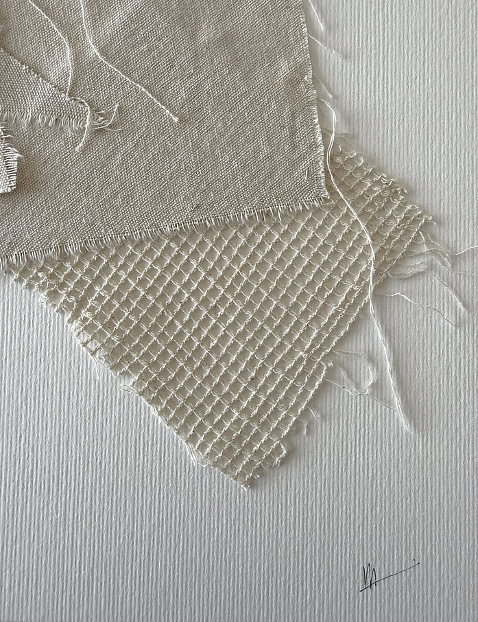detail of fabriano paper surface texture, soft frayed linen edges and handwritten signature lower right corner