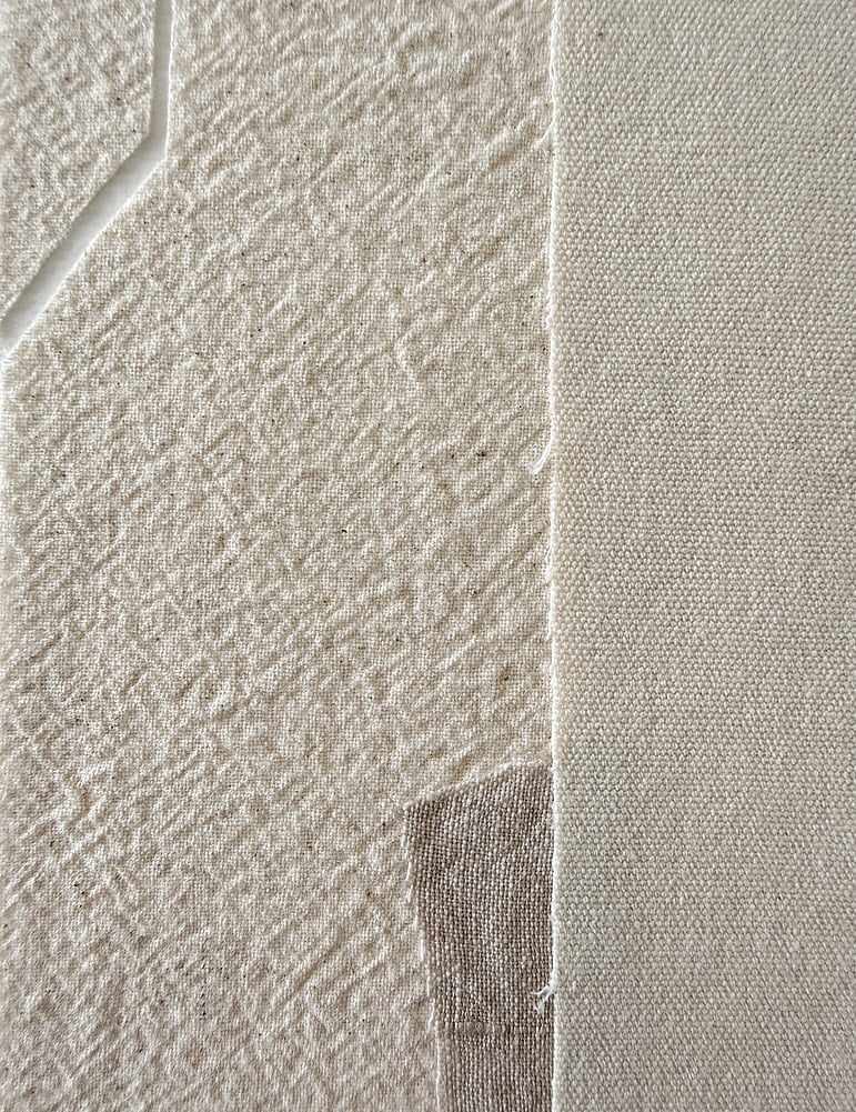 detail image of layered pale beige-toned linen and cotton fragments, showing woven texture and geometric cut-out in one linen fragment 