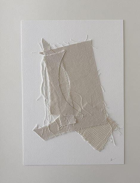 full image of layered collage with soft honey-toned cotton fragments on ivory fabriano, showing frayed edges, hanging threads and handwritten signature in lower right corner 