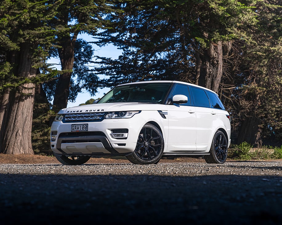Range Rover Sport front three quarter view among pine trees