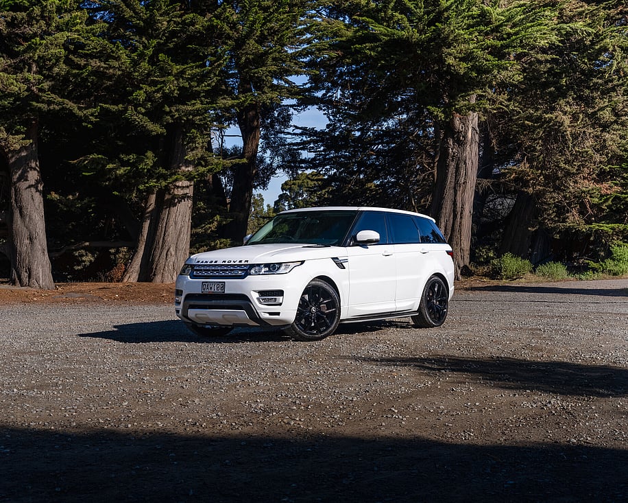 Range Rover Sport side profile parked on gravel track