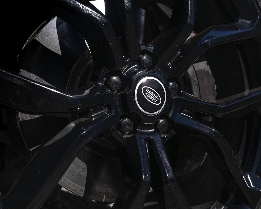 Close up of Range Rover black alloy wheel and brake caliper