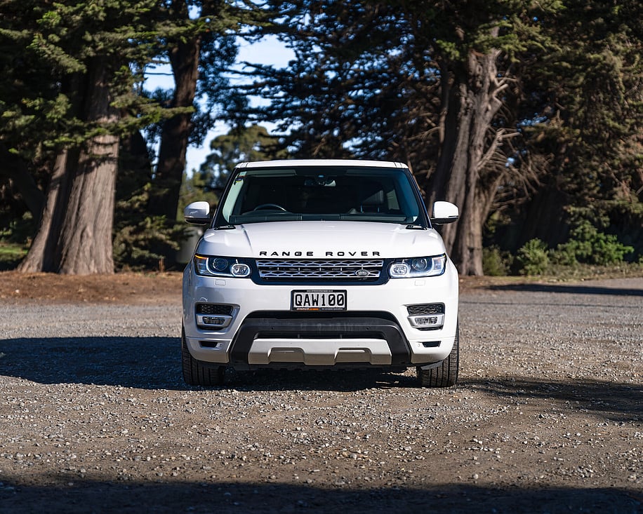 Range Rover Sport white front view on forest road