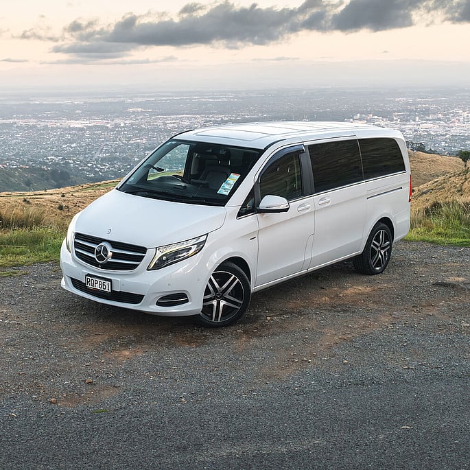 Mercedes V220d luxury van parked on hilltop at sunset