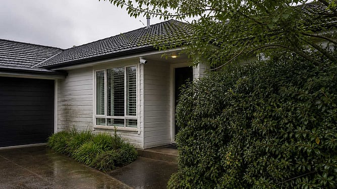 Hamilton home with trees obstructing security camera and gutters
