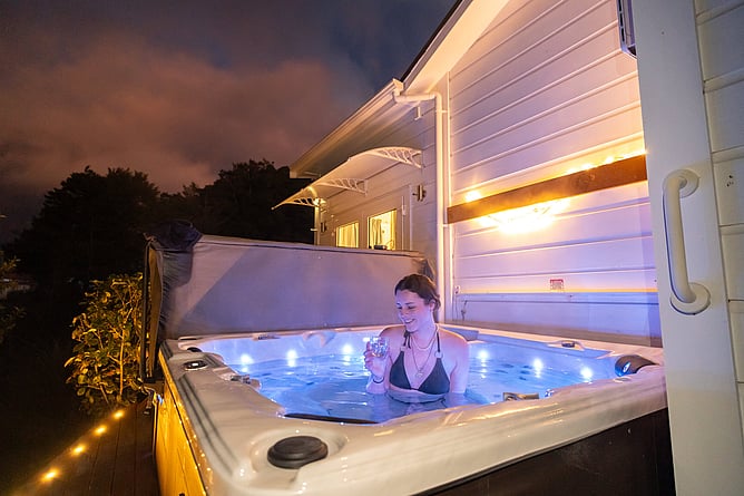 Relaxing in the private hot tub next to the Mangawhero Suite, with the soothing sounds of the Two Rivers