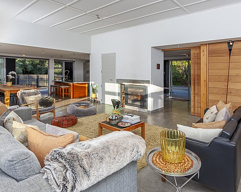 Chill out by the fire in the comfortable living area at Arcus retreat for women nz