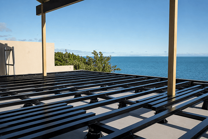 Site-specific engineered floating deck solution with no fixings to the building, Wellington region.