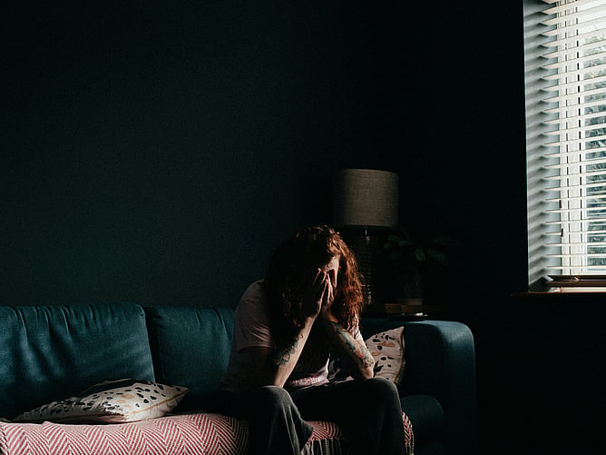 Woman on sofa sad ADHD inner critic RSD