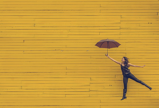 Woman holding an umbrella feeling happy ADHD