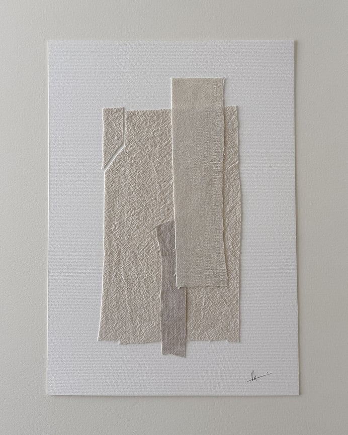 full image of layered collage with pale, beige-toned linen and cotton fragments on soft white fabriano, showing soft frayed edges and handwritten signature in lower right corner 