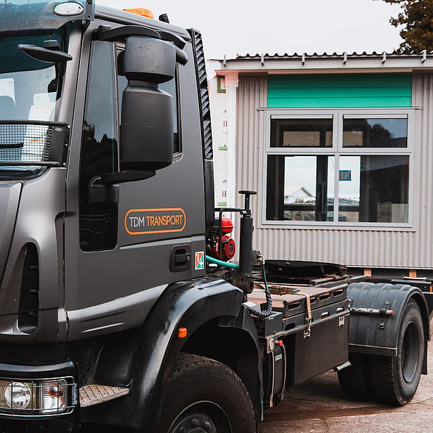 TDM Transport staff member moving modular homes in Hamilton, New Zealand 
