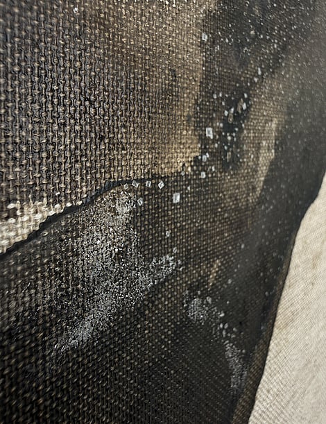 close-up of layered brown acrylic ink wash on linen, silica sand and granular salt texture
