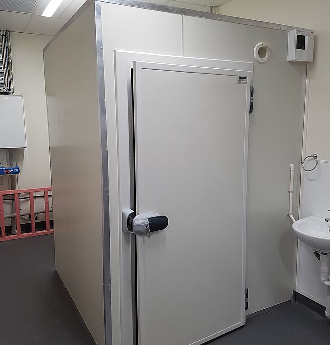 Interior of a walk-in cool room with insulated panel walls and door