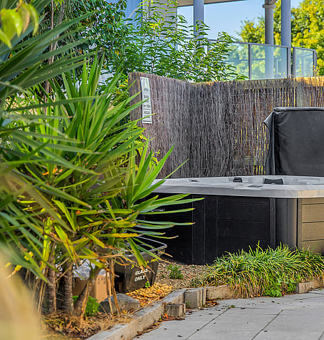 Private spa pool tucked beside native plantings and timber screening