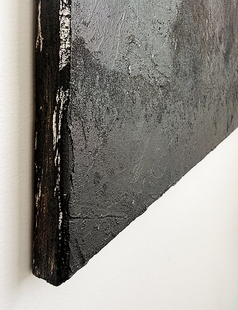 side view showing raised granular texture, layered mineral surface and canvas depth