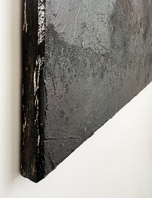side view showing raised granular texture, layered mineral surface and canvas depth