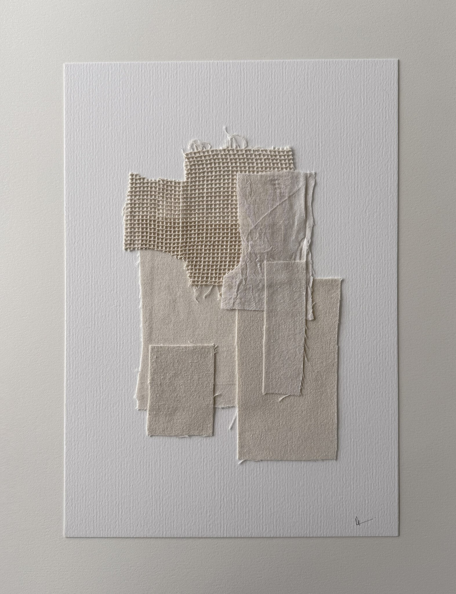 full image of layered collage of tactile sand-toned linen and cotton fragments on soft white fabriano, showing soft frayed edges and handwritten signature in lower right corner