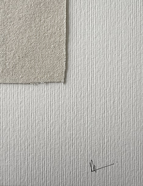 detail of fabriano surface texture, showing one soft frayed linen edge and handwritten signature lower right corner