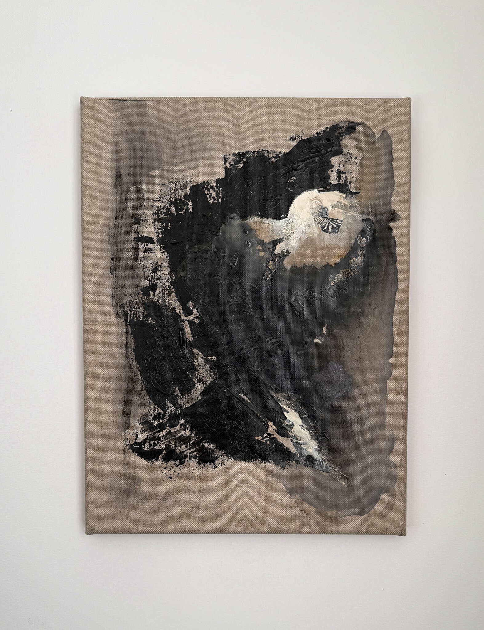 full image of a textural abstract painting on linen, showing layered surface movement with black, grey and cream acrylic, a pale cream bloom, sweeping diagonal impasto passages, charcoal smudging and iron oxide wash