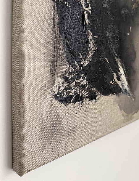 side view of black and pale cream impasto passages, charcoal smudging into linen, iron oxide wash in background