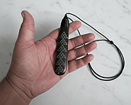 “Pounamu (New Zealand greenstone) piece featuring a laser‑etched Patikitiki flounder pattern, showing repeating geometric diamond motifs symbolising skill, creativity, and prosperity.”