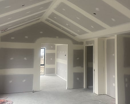 Worker plastering a wall