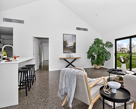 Image of light filled dining area and white washed modern kitchen in Collinson Street, Pirongia new home, by Waikato residential builders Whitechurch Construction Limited.