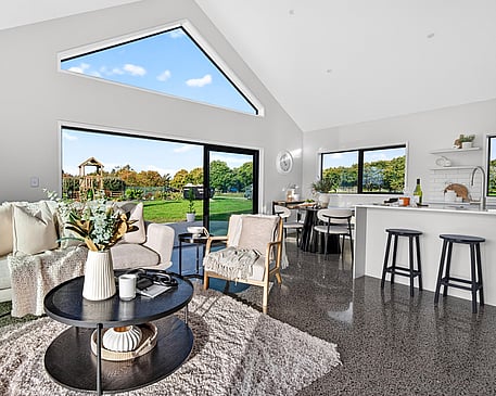 Image of light filled white washed modern kitchen with island bench in Collinson Street, Pirongia new home, by Waikato residential builders Whitechurch Construction Limited.