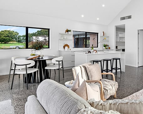 Image of light filled white kitchen and modern black appliances in Collinson Street, Pirongia new home, by Waikato residential builders Whitechurch Construction Limited.